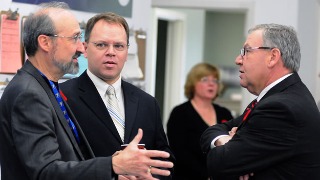 From left: Leo Gaessler, Ultra Electronics Maritime Systems, and Colin Stephenson, executive director of DEFSEC Atlantic, an annual defence and security exhibition and conference, chat with Premier Darrell Dexter before the announcement.