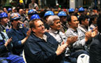 DSTN workers applaud during remarks at the opening ceremonies.