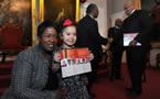 Frances Waterman-O'Connell and Nevaeh, daughter and granddaughter of Vincent Waterman, hold his plaque after the ceremony.