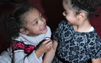 Nevaeh, granddaughter of  Vincent Waterman, (right) enjoys a break at the African Heritage Month launch event.