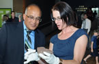 Leonard Preyra, Minister of Communities, Culture and Heritage, looks at the Superstar fossil held by Deborah Skilliter, curator of geology for the Nova Scotia Museum.