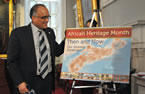 Communities, Culture and Heritage Minister Leonard Preyra stand beside this year's African Heritage Month poster that was unveiled at the launch.