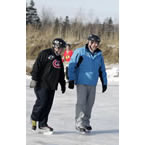 Premier Darrell Dexter and Health and Wellness Minister David Wilson skate in Membertou.