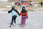 A couple of young skaters enjoy the day at a homemade outdoor rink in Membertou.