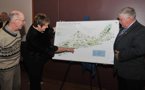 Martin Willison, Nova Scotia president of the Canadian Parks and Wilderness Society, Cole Harbour-Eastern Passage MLA Becky Kent, on behalf of Environment Minister Sterling Belliveau, and Natural Resources Minister Charlie Parker look at a map of protected areas at the announcement.