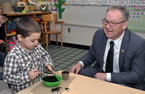 Premier Darrell Dexter helps Kayden Lethbridge with some potting soil during an Early Years announcement Rockingstone Heights School.