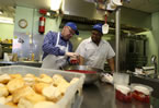 Premier Darrell Dexter helps Matt Jordan  prepare desserts for Meals on Wheels.