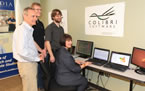 Education and Early Childhood Development Minister Ramona Jennex sits at a Colibri Software display with company president John Read, and company programmers Charlie Greene and Alex Sandford.