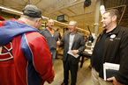 Premier Darrell Dexter chats with staff at Lake City Woodworkers, where many staff with special needs are employed.