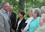 Premier Darrell Dexter chats with people on hand for the announcement Living Better: Nova Scotia's Plan for Seniors' Care.