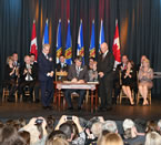 Premier Stephen McNeil sign his oath with Lt.-Gov. J.J. Grant and provincial deputy minister David Darrow.