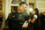 Robert Borden, who attended the school from 1966 to 1984, hugs Premier McNeil following the apology.