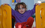 Three-year-old MaKayla Hall plays at the Edward Jost Children's Centre, the site of Tuesday's announcement.