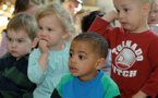 Children from the Mawio'mi Child Care Centre in Dartmouth listen intently during today's announcement.