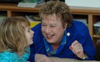 Community Services Minister Denise Peterson-Rafuse shares a smile with a child from Mawio'mi Child Care Centre in Dartmouth.