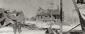 Soldiers standing guard on Kaye Street east of Gottingen Street, amid the destruction after the Halifax Explosion