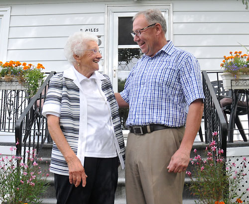 Dorothy Miles, 94, meets with Premier Darrell Dexter in front of her home.