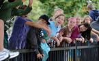 Mi’kmaq youth lean over a fence during Treaty Day ceremonies in Halifax.