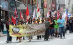 Mi’kmaq march down the street with a Treaty Day banner during festivities in Halifax.