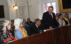 Premier Darrell Dexter rises to speak during the Treaty Day ceremony at Province House.