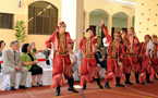 Premier Darrell Dexter and Fatima Assad, owner and principal of the Abu Dhabi Grammar School, watch students preform a dance.