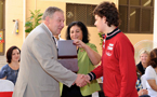 Premier Darrell Dexter shakes a Abu Dhabi Grammar School student's hand as Fatima Assad, owner and principal, looks on during a presentation at the school's official opening.