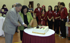 Premier Darrell Dexter and Fatima Assad, owner and principal of the Abu Dhabi Grammar School, cut a cake with a ceremonial sword at the official opening of Abu Dhabi Grammar School.