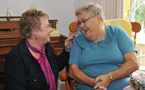 Community Services Minister Denise Peterson-Rafuse shares a laugh with Florence Acker, a resident of Miller Manor.