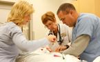 Emergency room nurse Krista Lloy, Janet Tucker, and emergency room paramedic Glen Etsell, do blood work on a patient at the QEII Health Sciences Centre emergency department.