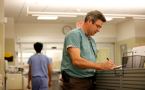 Emergency room doctor Kirk Magee fills out charts at the emergency room at the QEII Infirmary site.