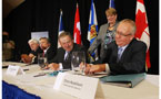 Premier Dexter looks on as Emera president and CEO Chris Huskilson (right) signs agreement.