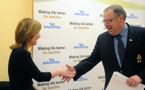 Premier Darrell Dexter shakes hands with Catherine Woodman, president and CEO, United Way of Halifax Region, during a 2-1-1 funding announcement.