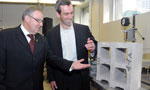 Premier Darrell Dexter discusses a clean technology concrete block with Robert Niven, president and founder of Carbon Sense Solutions.