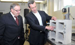President and founder of Carbon Sense Solutions Robert Niven explains the technology used to make their concrete blocks to Premier Darrell Dexter.