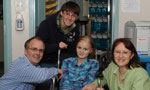 Eleven-year-old cancer patient Olivia Mason and her family in the  the Berman Zebrafish Laboratory.