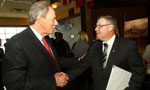 Premier Darrell Dexter shakes hands with Jim Irving, CEO, Irving Shipbuilding. 
