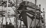 A welder works in front of a steel trawler being build at Halifax Shipyards.