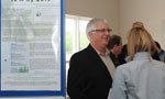 Environment Minister Sterling Belliveau talks to attendees after the announcement.