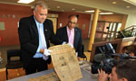 Communities, Culture and Heritage Minister David Wilson holds a copy of The Halifax Herald from 1941. 