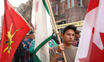 A young Mi'kmaw marcher carries a flag during Treaty Day celebrations.