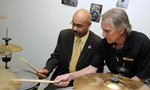 Billdidit's Bill Coady, right, gives Economic and Rural Development and Tourism Minister Percy Paris a few drum tips.