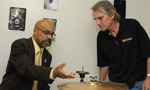 Economic and Rural Development and Tourism Minister Percy Paris and Billdidit's Bill Coady, discuss how his invention, the Coady clutch, works with hi-hat cymbals.
