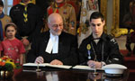 Speaker of the House of Assembly Gordie Gosse with chief petty officer Gabriel Vinette, Royal Canadian Sea Cadet Corps, Shearwater, signing the commemorative message book