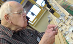Gerald Wright does some delicate work on a model of the Titanic. The model makers have put in more than 2,000 hours on the project so far.