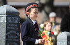 A boy prepares to place a rose at one of the Titanic gravesites during the Titanic Spiritual Ceremony at the Fairview Lawn Cemetery.