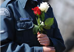 A young cadet holds two roses to be placed on one of the Titanic graves.