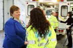 Health and Wellness Minister Maureen MacDonald talks with paramedic Nancy Habib as paramedic Brad Landry talks to media in the background.