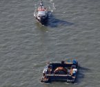 Nova Scotia Power and OpenHydro's turbine is towed in Halifax Harbour before being deployed in the Bay of Fundy.