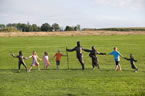 Some children pose for a photo with the Expulsion Sculpture.