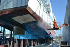 A ship sits in dry dock at Shelburne Shipyards as it is being repaired.